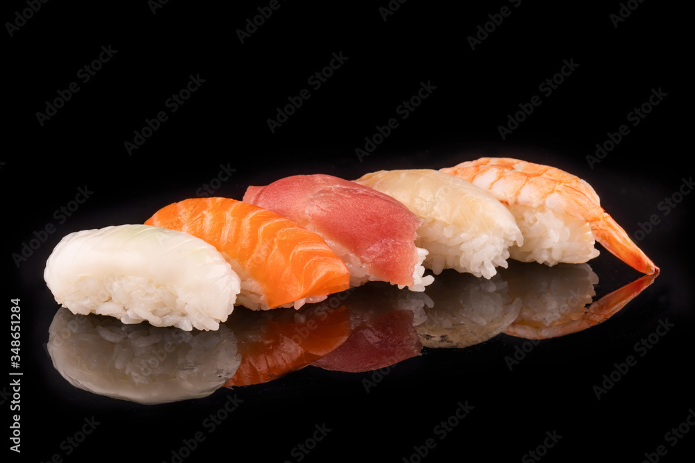 Simple sushi nigiri maki set isolated on black background. Various selection of traditional japanese Simple sushi nigiri maki set isolated on black background. Various selection of traditional japanese