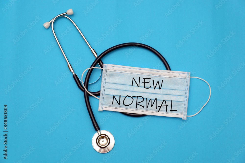 New Normal concept of face mask and stethoscope on a blue background. New Normal concept of face mask and stethoscope on a blue background.