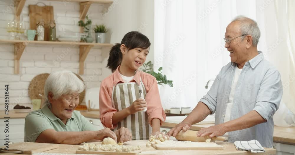 Senior asian couple and their granddaughter having fun together, singing while preparing pastry for dumplings - childhood memories, family ties concept 4k footage Senior asian couple and their granddaughter having fun together, singing while preparing pastry for dumplings - childhood memories, family ties concept 4k footage