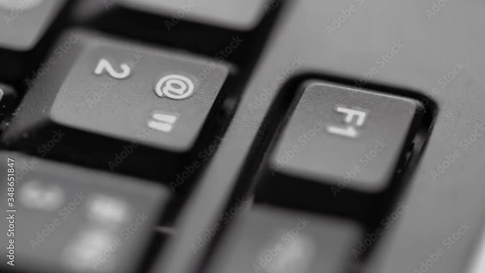 Black computer keyboard closeup on black background. Slow motion on keys. Low depth of field. Dark computer internet technology background. Business button communication. Hands of hacker or programmer Black computer keyboard closeup on black background. Slow motion on keys. Low depth of field. Dark computer internet technology background. Business button communication. Hands of hacker or programmer