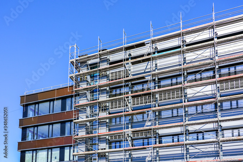 renovation of the facade of a house and thermal insulation using scaffolding