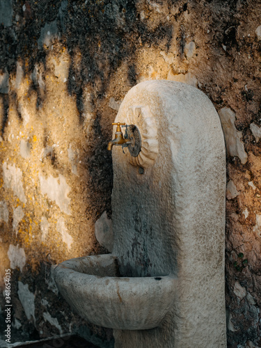 ancient fountain . french streets. old wall. image with selected focus