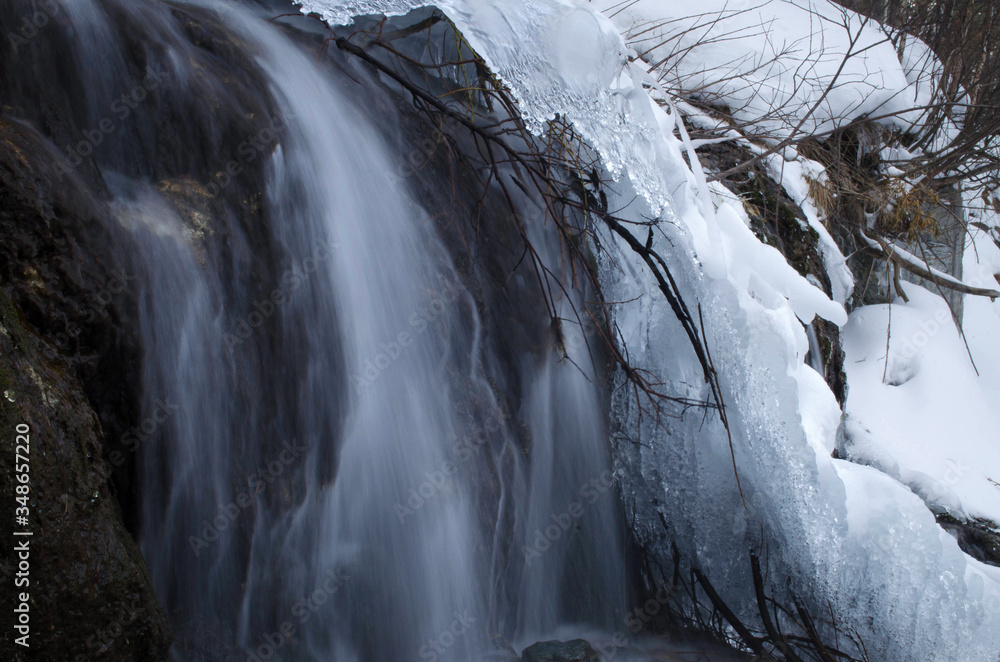 waterfall in winter in the mountains and in the ice waterfall in winter in the mountains and in the ice
