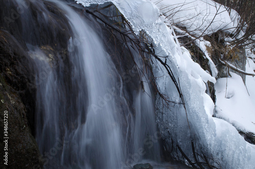 waterfall in winter in the mountains and in the ice