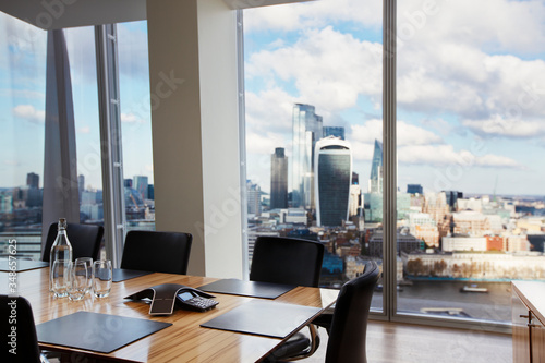 Modern conference room overlooking highrise buildings and city photo