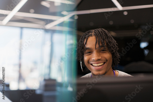 Portrait smiling businessman with headset at computer