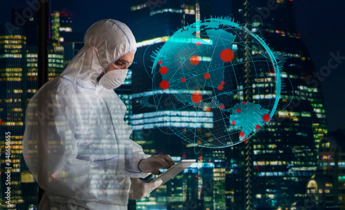 Scientist in clean suit working late during coronavirus pandemic