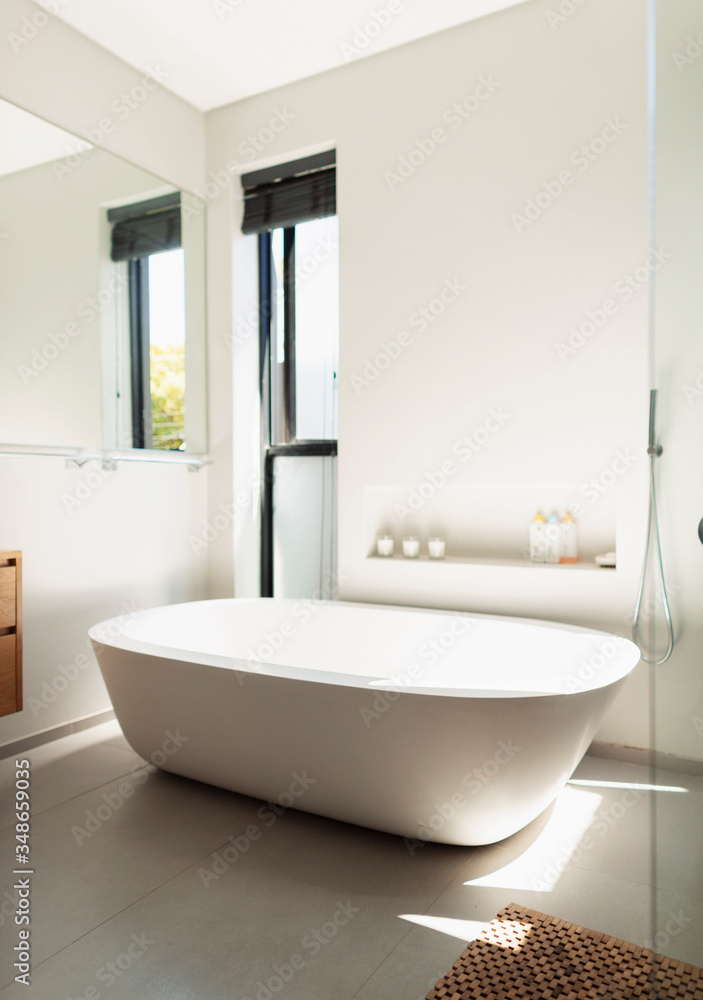 Soaking tub in tranquil, modern home showcase bathroom Soaking tub in tranquil, modern home showcase bathroom