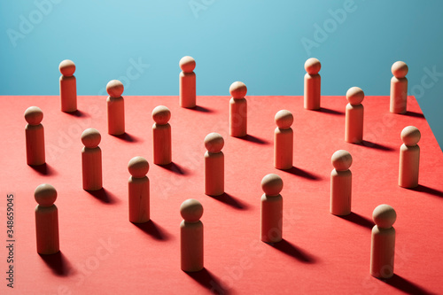 Wooden pawn chess pieces on red surface