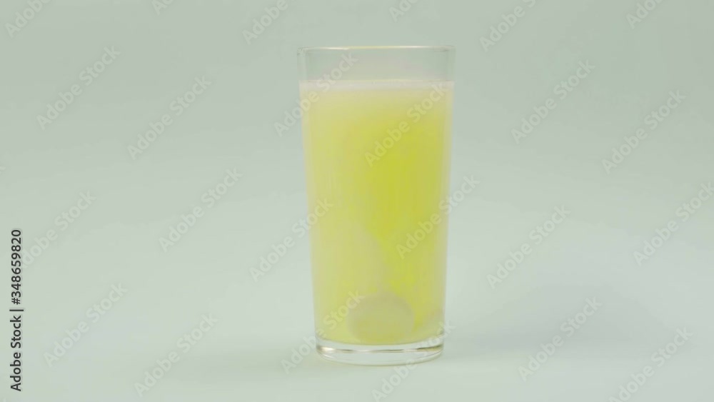 Pill falling down in glass with water. effervescent tablet aspirin. Timelaps Pill falling down in glass with water. effervescent tablet aspirin. Timelaps