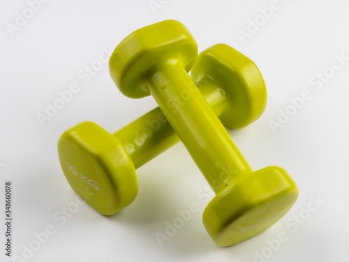 Small green dumbbells linked behind white background