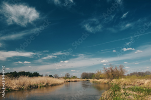 Fototapeta Naklejka Na Ścianę i Meble -  Blue sky and clouds on a background of a spring river.