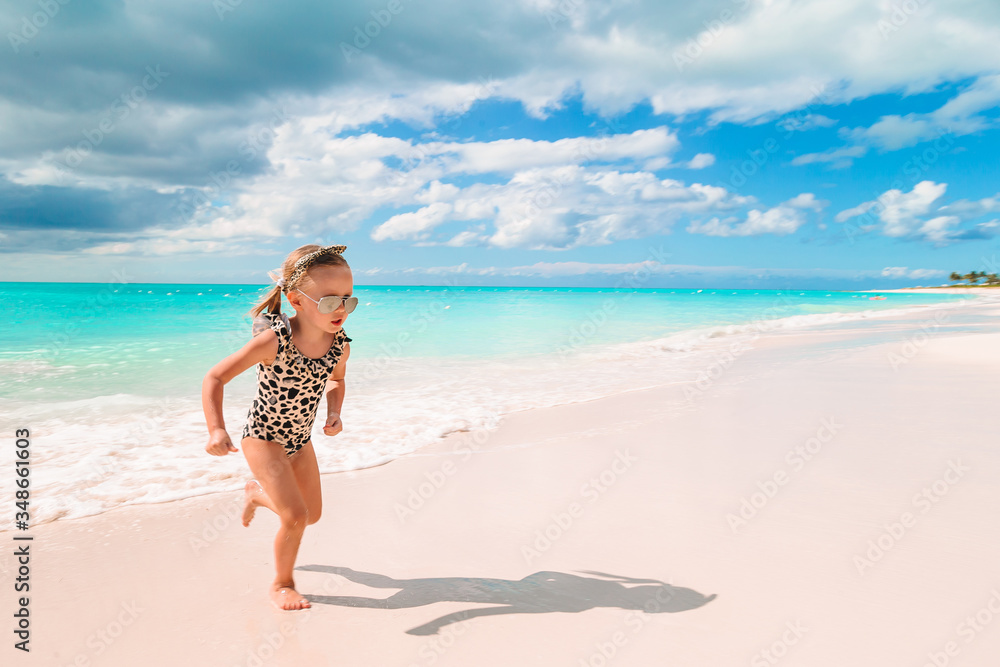 Cute little girl at beach during caribbean vacation Cute little girl at beach during caribbean vacation