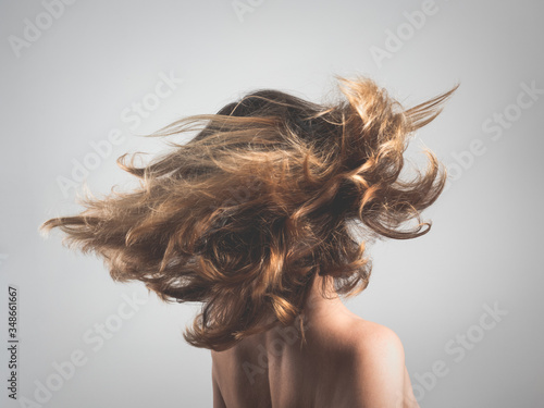 Girl tosses hair in motion blur  photo