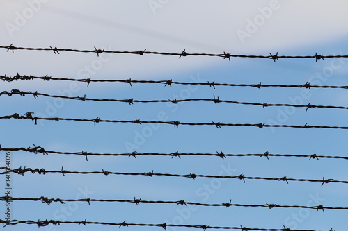 Barbed wire on a blue sky background