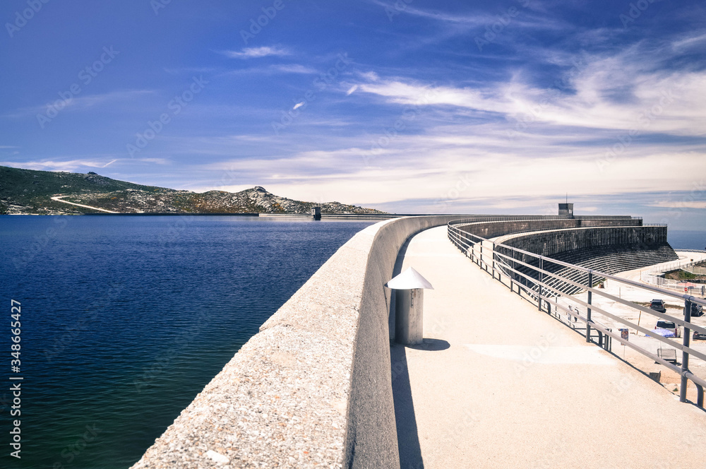 Concrete Dam in the mountains near to the blue lake