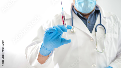 Doctor with a syringe filled with the drug remdesivir