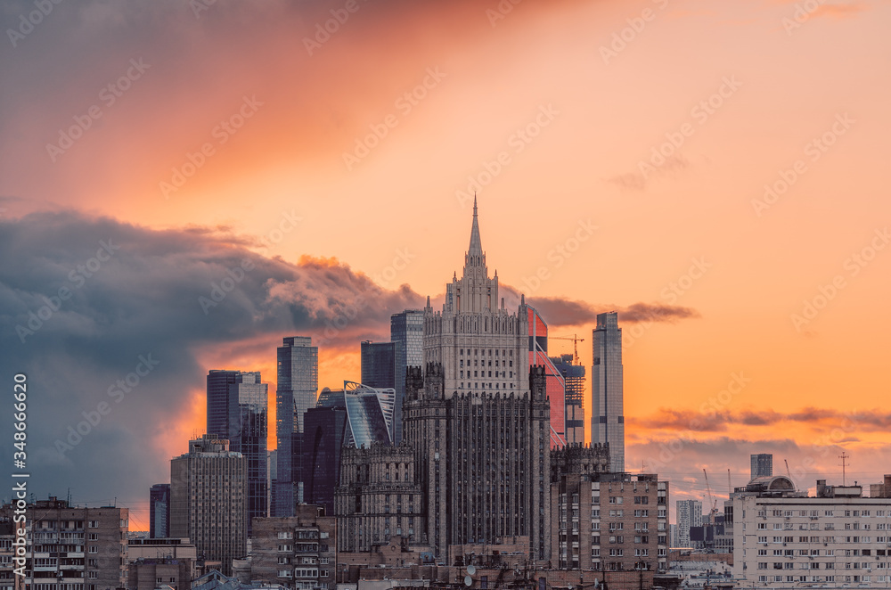 City landscape during a fiery sunset. View of the Ministry of Foreign Affairs and the buildings of the Moscow City business center from the observation deck of the Cathedral of Christ the Savior.