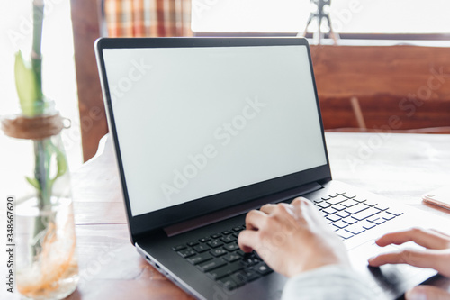 young woman working freelance at computer at home on terrace