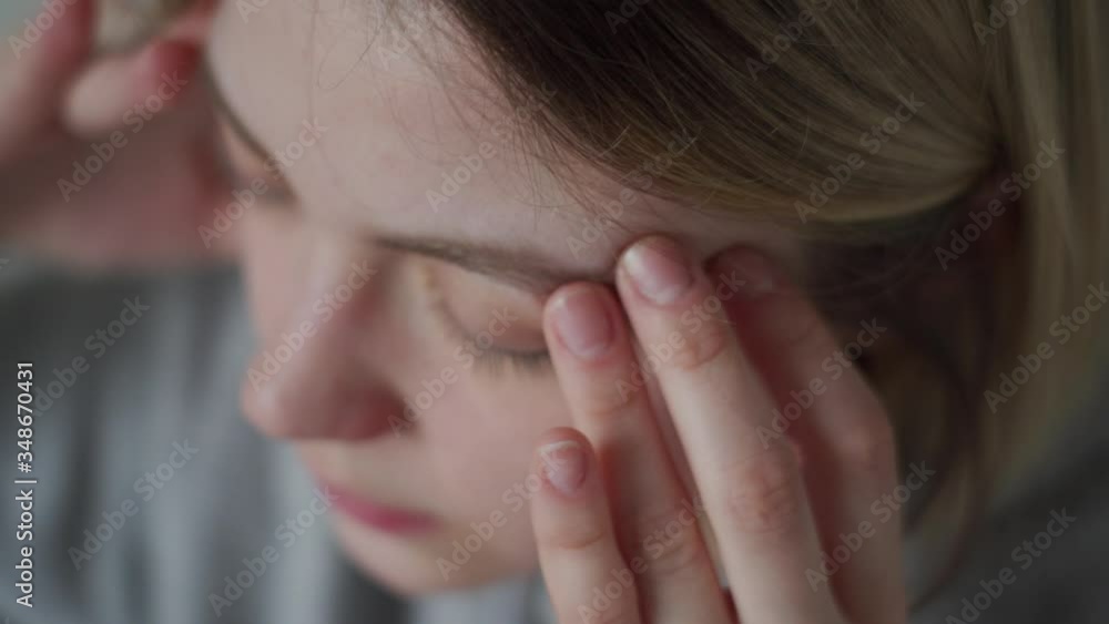 Massage with fingers. The girl has a migraine, headache, malaise. Massage with fingers. The girl has a migraine, headache, malaise.