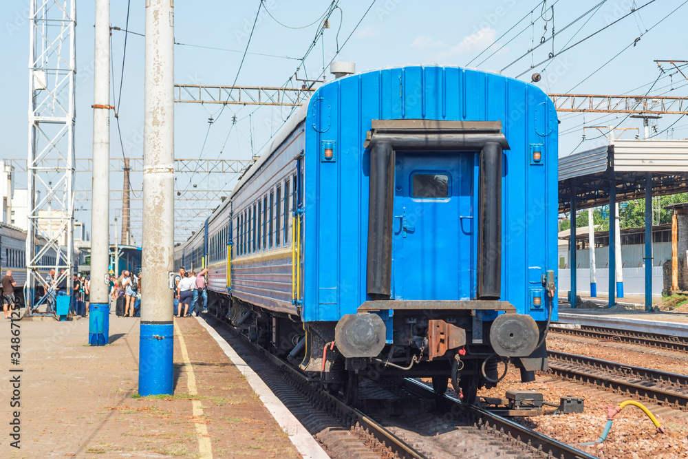 Passengers boarding the train at the train station. Train at the station Passengers boarding the train at the train station. Train at the station