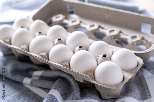 One dozen white eggs in a carton package photo