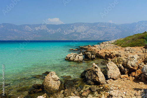 Shore of the island in the Aegean Sea on a background of mountains