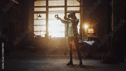 Talented Female Artist Wearing Virtual Reality Headset and Holding Digital Joysticks. She's Working on a Painting or Sculpture, Uses Motion Controllers To Create Concept Art. Creative Modern Studio.