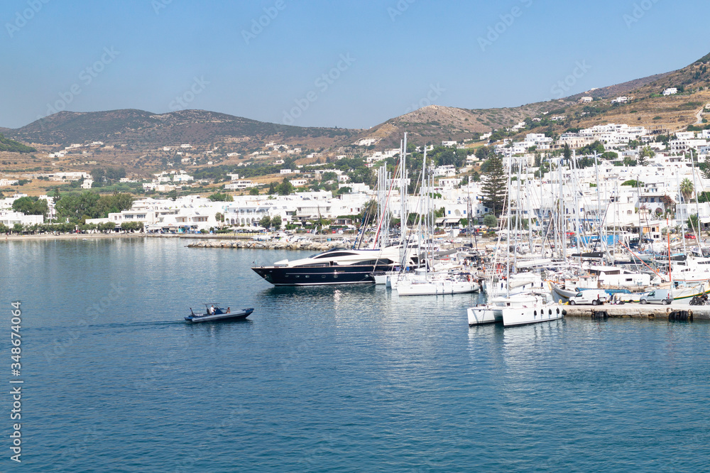 View of the entrance of a speedboat to the marina on one of the Cyclades islands in the Aegean Sea, Greece