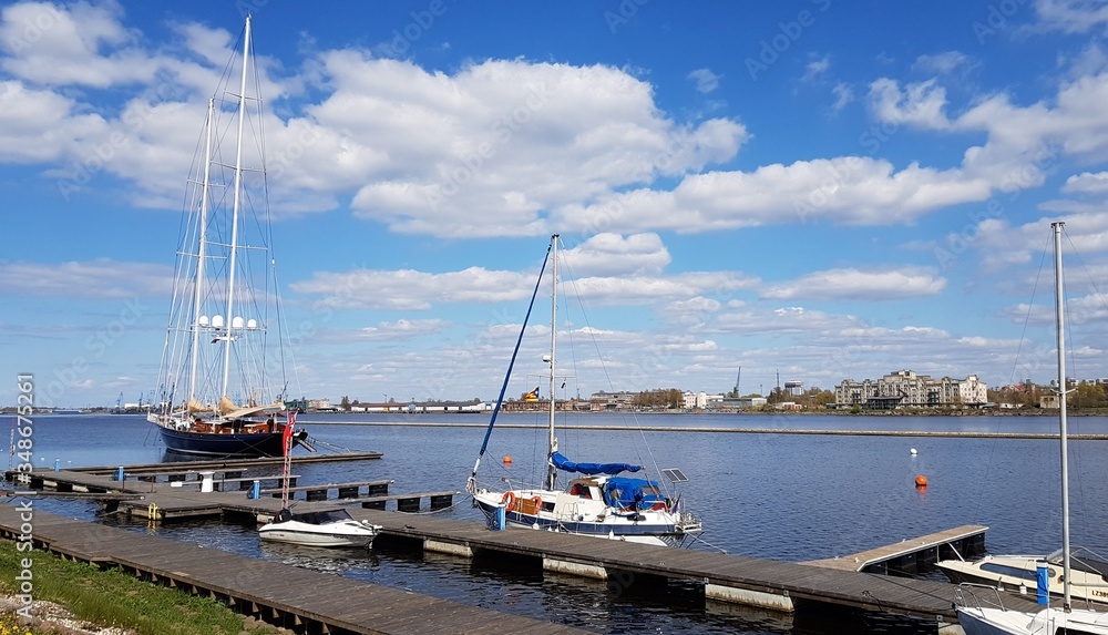 Yachts moored at a pier on the river in the Latvian capital Riga in spring 2020