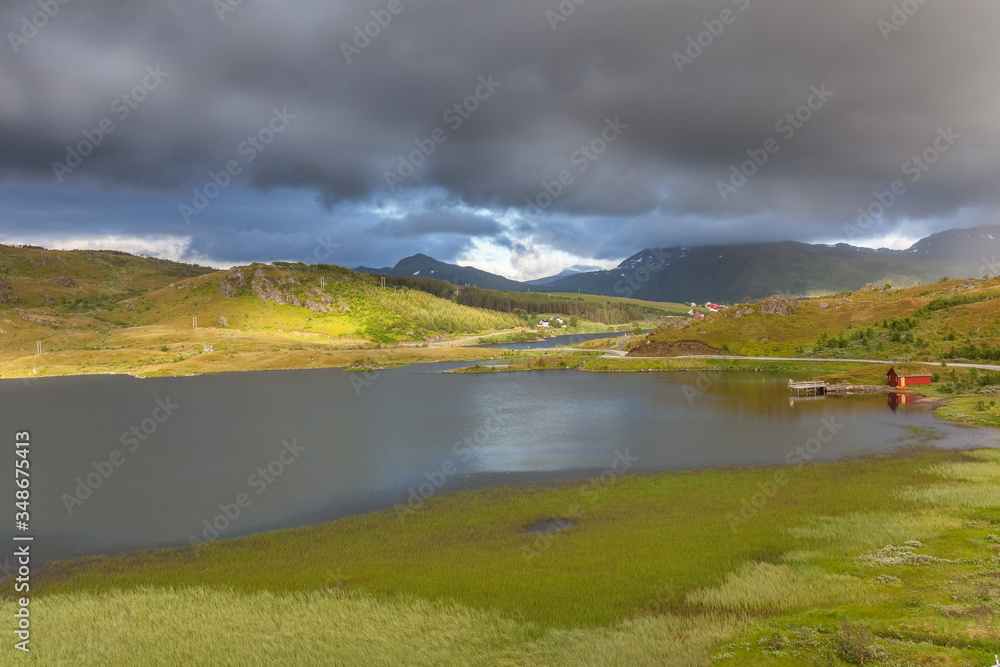 lake under a cloudy sky on the road to Unstad, Lofoten