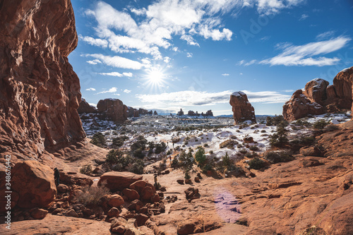 Double Arch at Arches National Park in snow when sun is rising.