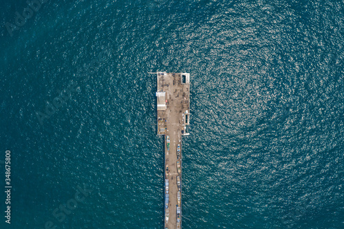 Aerial view of La Libertad pier, with the boats lined up on the pier, the ocean and waves. El Salvador © Daniel Umana 😎📸