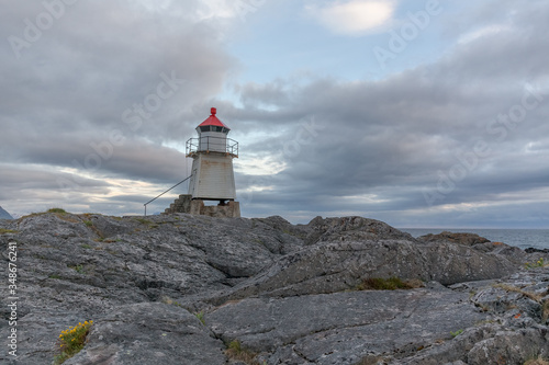 Lighthouse in Norwegian fjords, Norway. Sea mountain landscape view.