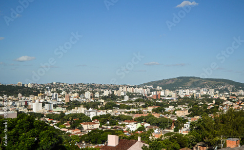 Panoramic view of Porto Alegre city, and the hills behind the buildings on a sunny day.