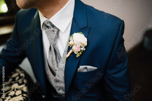 photo of a groom's suit with flowers