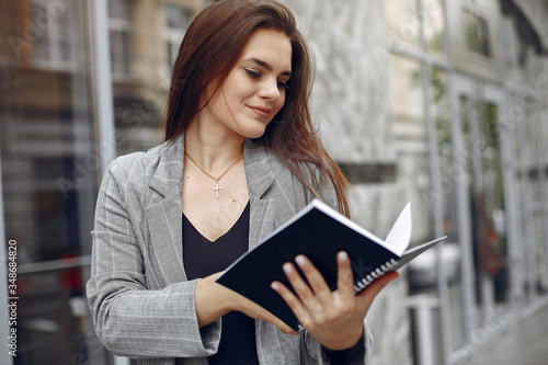 Beautiful woman working. Busineswoman in a stylish clothes. Lady use the notebook
