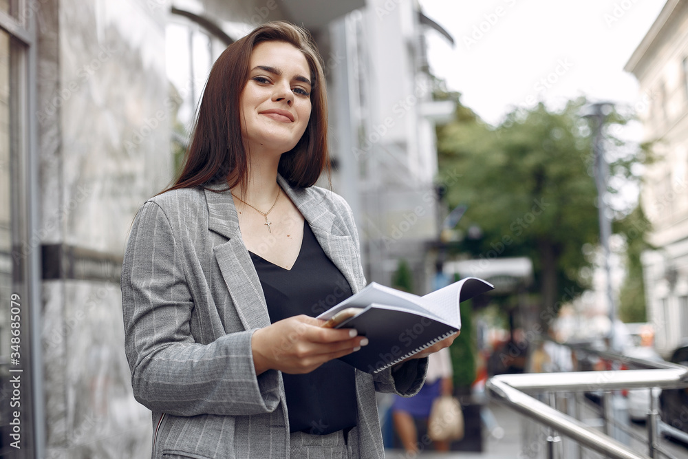Beautiful woman working. Busineswoman in a stylish clothes. Lady use the notebook Beautiful woman working. Busineswoman in a stylish clothes. Lady use the notebook
