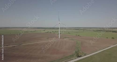 Slow orbit shot of single wind generator right to left