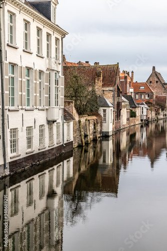 Buildings around channels with reflection in Bruges