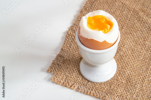 Obraz na plátně a boiled egg standing on a sacking on a stand close up