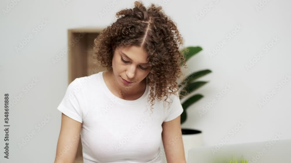Attractive business woman working on laptop in her workstation. Attractive business woman working on laptop in her workstation.