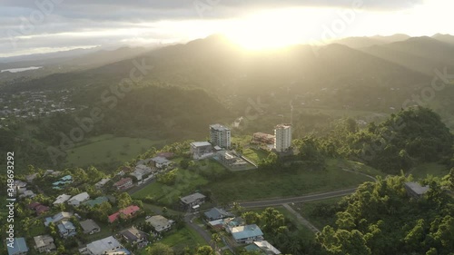 Sun setting over mountains surround pacific capital city Suva 