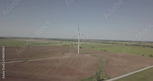 Slow orbit shot of single wind generator left to right
