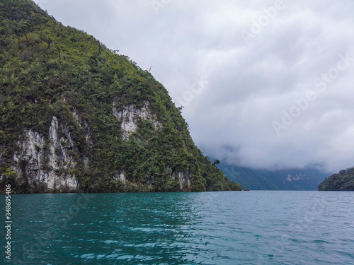 View of the Laguna Brava in Guatemala, Huehuetenango, on a cloudy day but still you can see the blue color of the water and its green mountains.
