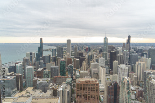 aerial view of chicago  showing some of the tallest buildings in the city. You can also see the lake and in the background you can see the sunset