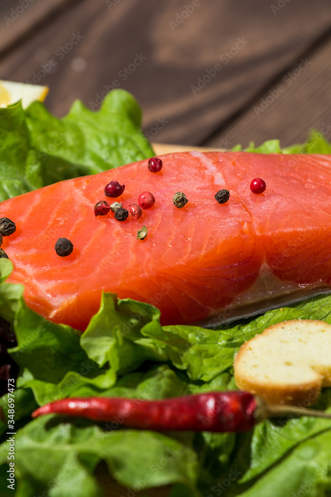 red fish fillet on a wooden background. trout, lettuce, crackers, toasts, red pepper. preparing breakfast red fish fillet on a wooden background. trout, lettuce, crackers, toasts, red pepper. preparing breakfast