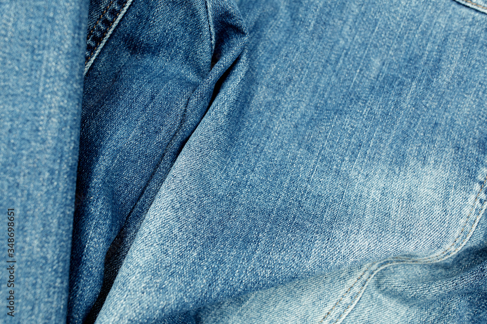 Naklejka premium close up of blue jeans fabric with button, jeans fabric background image, blue jeans texture