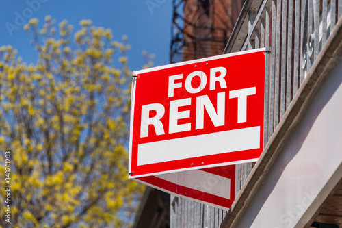 For rent sign posted in front on balcony fence photo