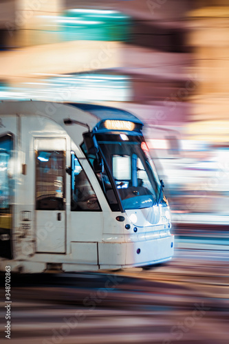 Motion Train in Street at Night, tram, movement, lights of buildings background